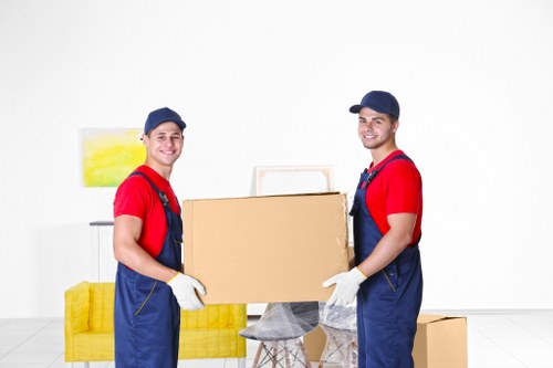 Moving team handling packed boxes during a home removal service