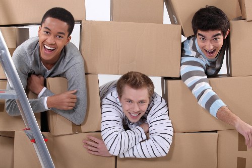 Removal team loading items for a house move