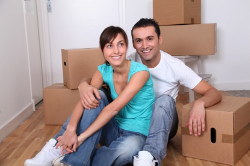 Specialist movers handling a baby grand piano in North London
