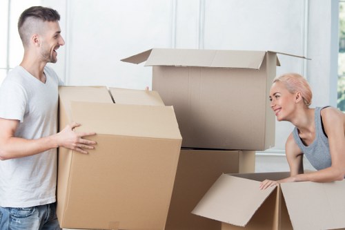 Mover wearing PPE while carrying household items